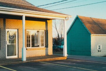 A serene image of suburban buildings and parking lot during golden hour.